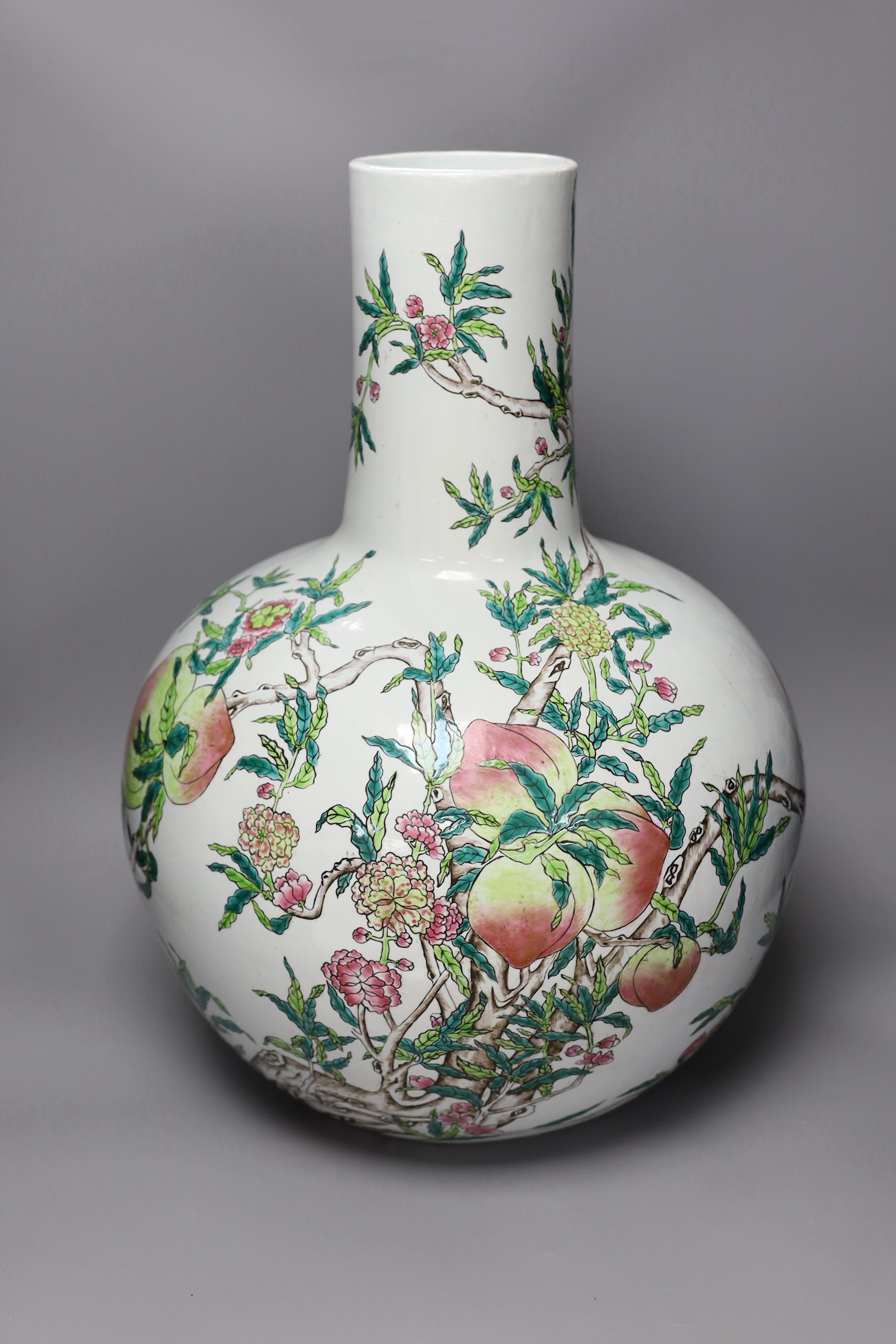 A large Chinese famille rose ‘nine peach’ bottle vase, 58cms high